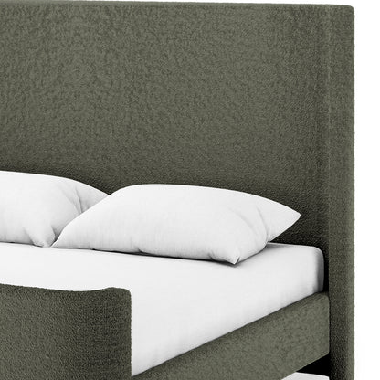 Palmira Queen Boucle Fabric Bed Frame in Dark Green, featuring a tall textured headboard and footboard, white mattress, and pillows. The sleek sleigh design offers a sophisticated, modern look.
