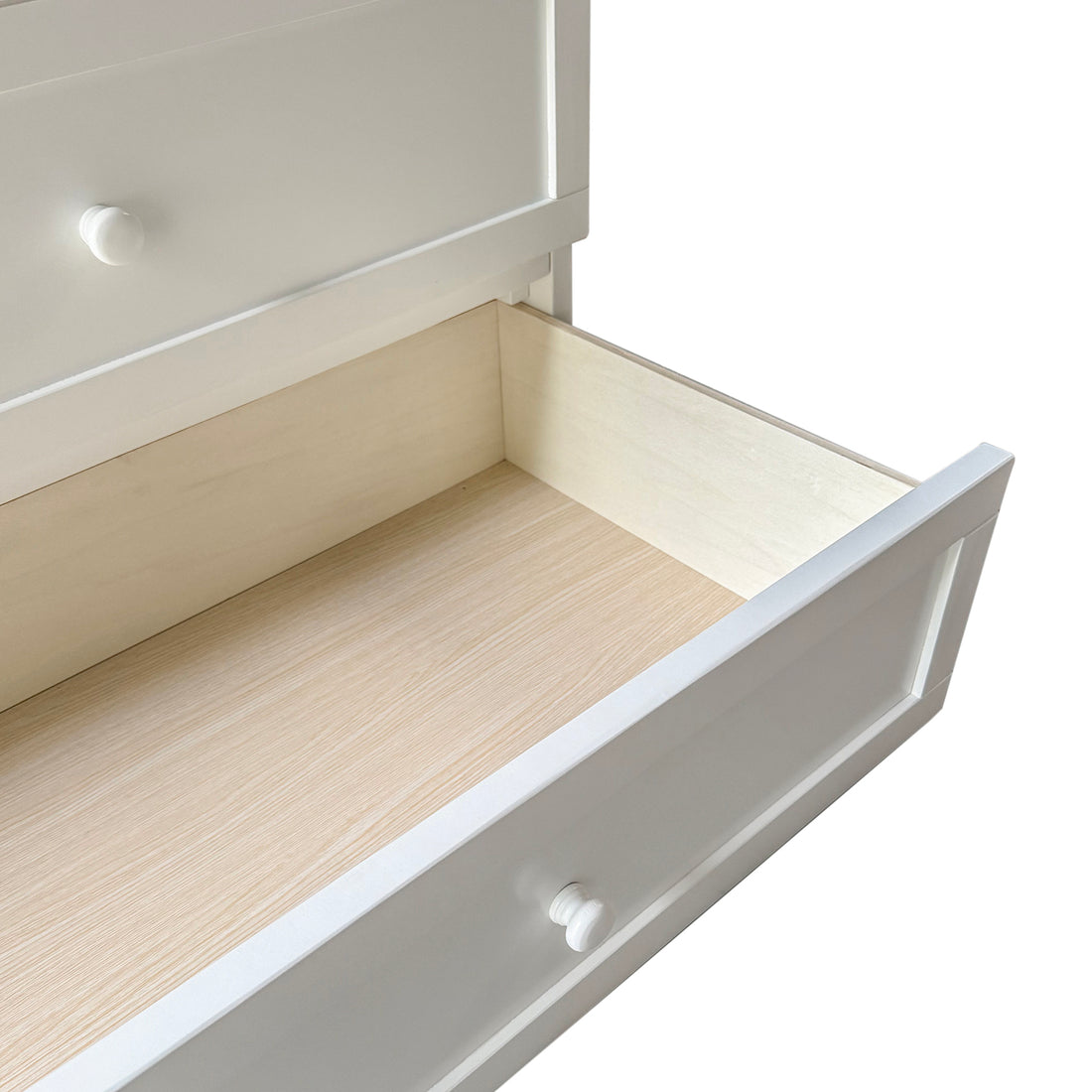 Zoomed-in shot of the functional storage in the white convertible bed unit, with an empty drawer