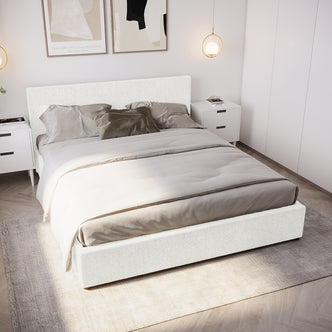 Renata Queen Bouclé Gas Lift Bed Frame in Cream White, featuring a low-profile design, upholstered headboard, neutral bedding, and gas lift storage, set in a contemporary bedroom with white nightstands and abstract prints.