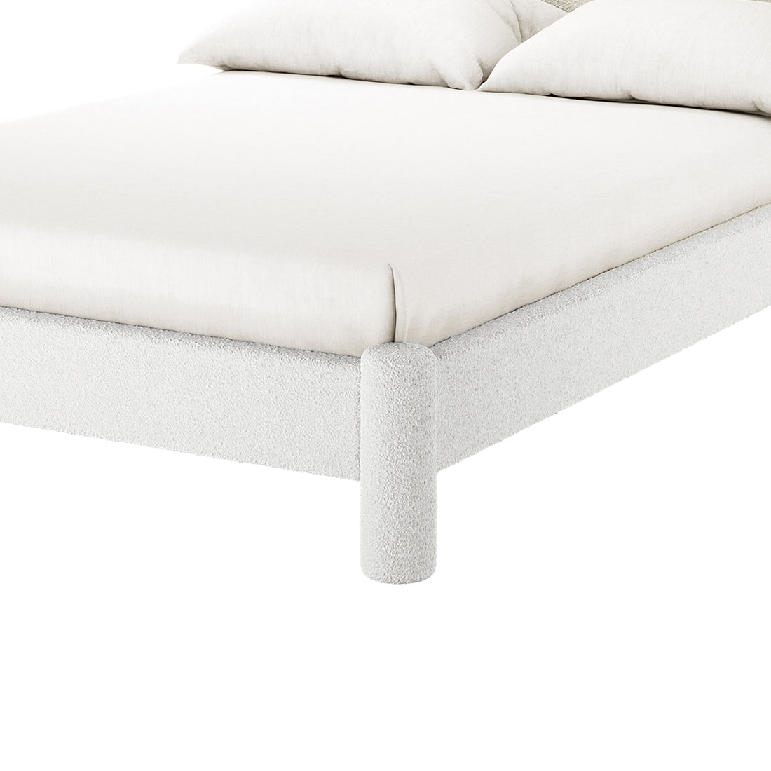 Close-up of the Rhoda Double Boucle Fabric Bed Frame in Cream White, showcasing its textured, rounded fabric frame and cylindrical leg, with a light-colored mattress and pillows visible.