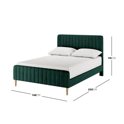 Seneca Upholstered Velvet Bed - Green Double, featuring channel-tufted design, white mattress, pillows, and tapered wooden legs, presents a luxurious and stylish focal point for any bedroom.