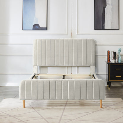 Seneca Double Upholstered Velvet Bed – Slate features a tall, channel-tufted headboard and footboard in pale fabric, light-wood legs, and exposed slatted base, set in a minimalist bedroom scene.