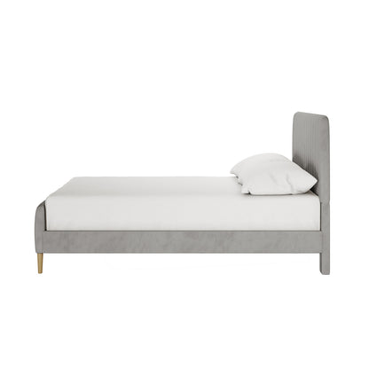 Seneca Double Upholstered Velvet Bed – Slate, featuring a light gray, channel-stitched headboard, low footboard, and tapered wood-tone legs. Dressed in white bedding, showcasing minimalist elegance and robust construction.