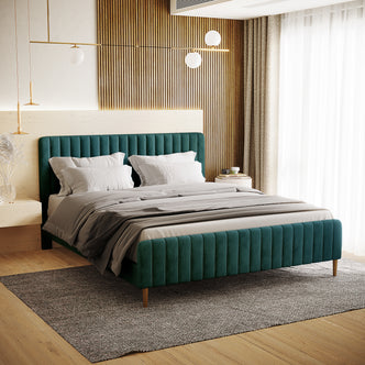 Seneca King Curved Velvet Fabric Bed Frame in Green, featuring a low-profile, channel-tufted headboard with deep teal upholstery, paired with pale linens and light-wood nightstands, creating a luxurious bedroom setting.