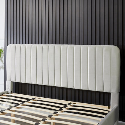 Seneca King Upholstered Velvet Bed – Slate, featuring a tall, padded headboard with vertical channel-tufting and a slatted wooden base, set against a dark ribbed wall panel.