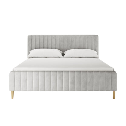 Seneca King Upholstered Velvet Bed in Slate with a tall, channel-stitched headboard, matching footboard, light gray fabric, white bedding, and exposed wooden legs, offering a luxurious and sturdy design.