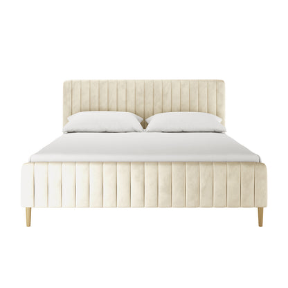 Seneca King Upholstered Velvet Bed – Sandy White features a light cream fabric with vertical channel tufting and tapered wooden legs, offering a plush and elegant centerpiece for any bedroom.