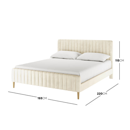 Seneca King Upholstered Velvet Bed – Sandy White features a vertically-channeled headboard, matching footboard, slim tapered wooden legs, and plush velvet upholstery, offering a sophisticated centerpiece for any bedroom.