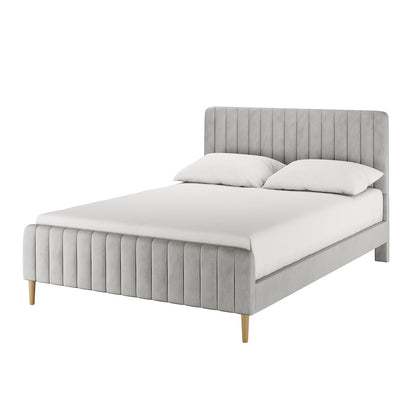 Seneca Queen Upholstered Velvet Bed – Slate, featuring a low-profile frame with vertically channel-stitched headboard and footboard in light gray fabric, resting on simple wooden legs with a mattress and pillows.