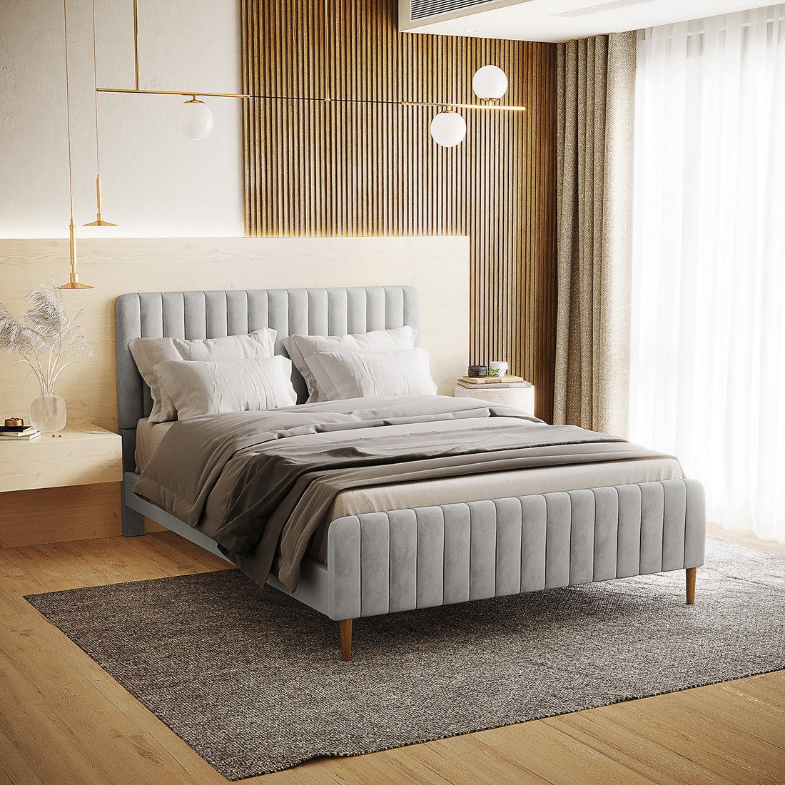 The Seneca Queen Upholstered Velvet Bed – Slate features a low-profile, channel-tufted design with neutral bedding, set against a vertical wood-slat accent wall with minimalist pendant lights.
