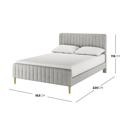 Seneca Queen Upholstered Velvet Bed – Slate features a light grey fabric, channel-tufted headboard and footboard, low-profile side rails, and tapered wooden legs, showcasing modern elegance and comfort.