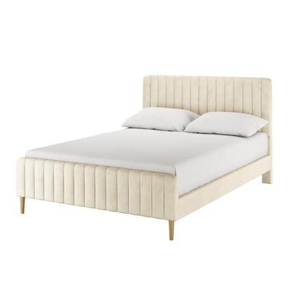 Seneca Queen Curved Velvet Fabric Bed Frame in Sandy White, featuring a vertically channel-tufted headboard and footboard with plush velvet upholstery, displayed with a fitted sheet and pillows on a plain background.