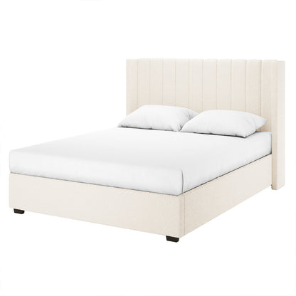 Septima & Fulvia Bouclé King Bed Base & Winged Headboard in Cream White features a cream-colored upholstered frame with a tall, channel-stitched headboard, fitted with a white mattress and pillows on dark block feet.