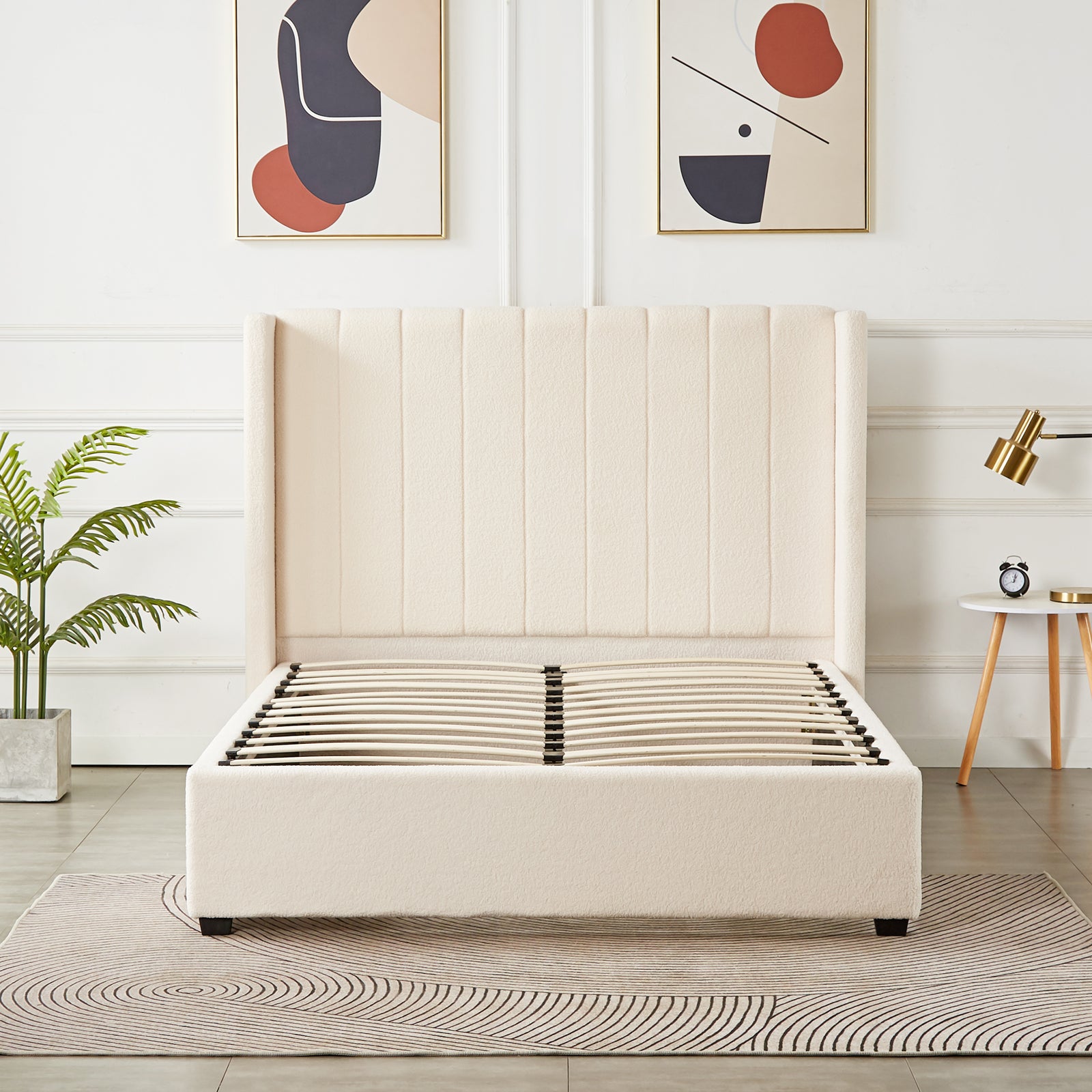 Septima & Fulvia Bouclé Queen Bed Base & Headboard in Cream White, featuring a tall, wing-style, vertically channel-stitched headboard, with visible wooden slats, complemented by a neutral rug and abstract art prints.