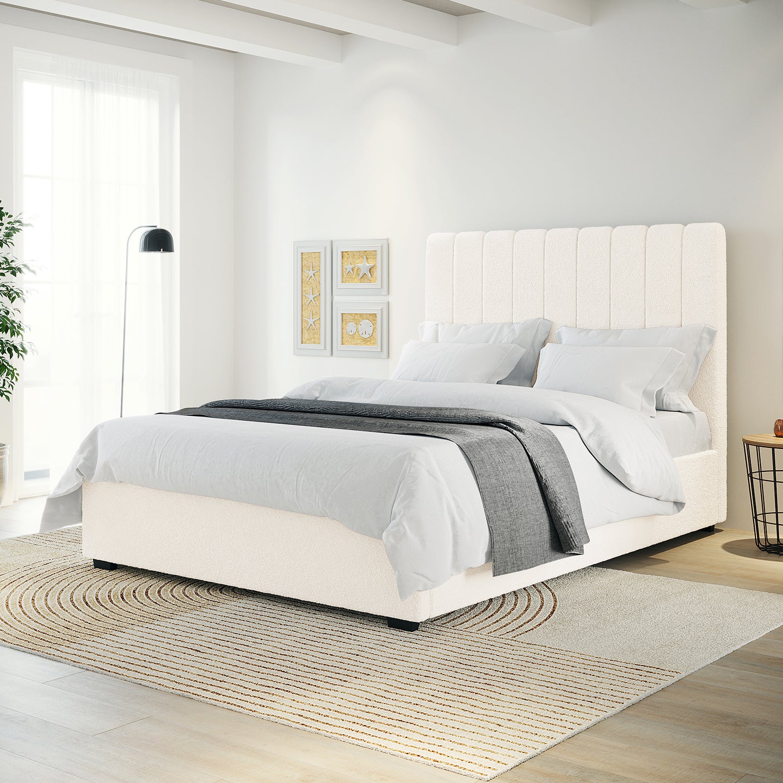 Septima & Gratiana Queen Bed Base & Headboard in Cream White features a vertically channeled, upholstered headboard. Displayed in a bright bedroom with light grey bedding, a neutral rug, and minimalist decor.