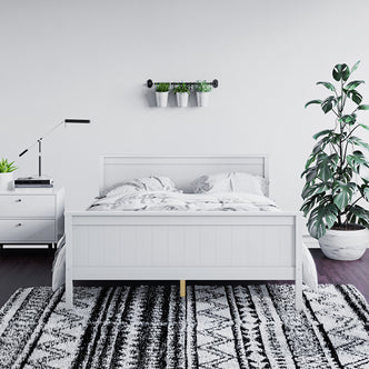 Tertia Solid Pine Timber Bed Frame Double in a bedroom setting, featuring a robust wooden structure with engineered slats, showcasing its durability and elegant design against an indoor backdrop with houseplants.