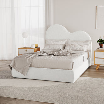 Thales Double Curved Boucle Fabric Bed Frame in Cream White with a cloud-shaped headboard, set in a minimalist bedroom, featuring neutral bedding, wooden bedside tables, and floor-to-ceiling curtains.