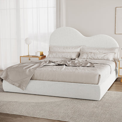 Thales King Curved Boucle Fabric Bed Frame in Cream White features a cloud-like headboard, neutral-tone bedding, light wood nightstands, globe lamp, and sheer curtains, creating a modern, serene bedroom scene.