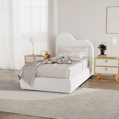 Thales Single Curved Boucle Fabric Bed Frame in Cream White, showcasing a cloud-like headboard. Features neutral silky bedding, mid-century nightstands, brass lamps, and a textured area rug in a minimalist bedroom setting.