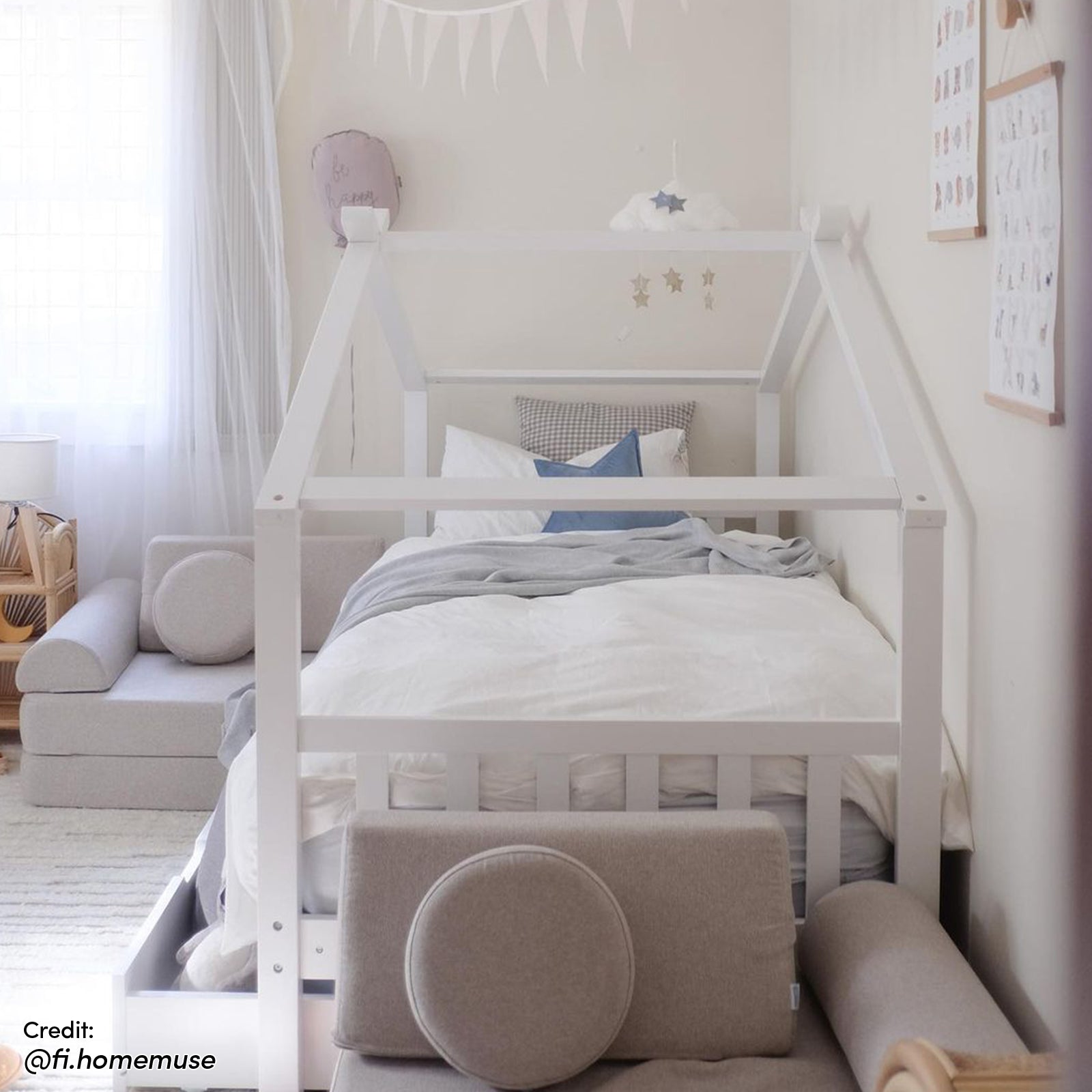 Tucker Solid Pine Timber Kids Bed with Drawers White features a house-shaped frame with white linens, light grey throw, and accent pillows, set in a cozy, Scandinavian-inspired children’s bedroom.