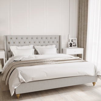 Vilania Tufted Fabric Bed Frame - King - Grey features a tufted headboard, solid wood frame, and low-profile design, shown with a white pillow on a bed, emphasizing luxury and durability.