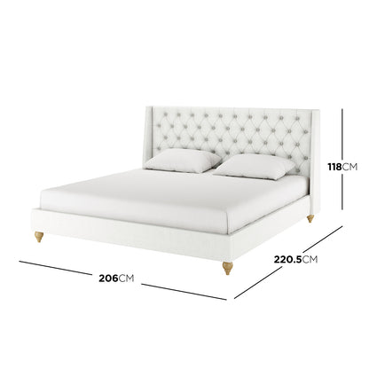 Vilania Tufted Fabric Bed Frame - King, showcases a tall, button-tufted headboard, off-white upholstery, and turned wooden legs. Includes illustration mattress and pillows. Dimensions: Height 118cm, Depth 206cm, Width 220.5cm.