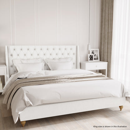 Vilania Tufted Fabric Bed Frame - Super King - Off White, featuring a tall button-tufted headboard, white linens, and beige throw, with a white nightstand and pendant lamp beside it.