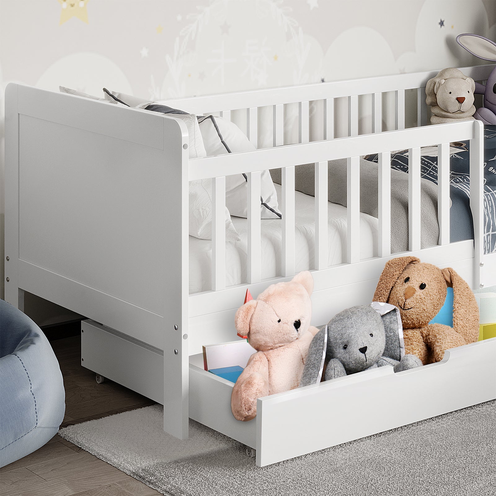 Zane Kids Solid Pine Timber Single Bed w/ Drawer - White, featuring side rails, dressed in white linens with a grey throw, trundle drawer, and plush animals, set on a grey rug.