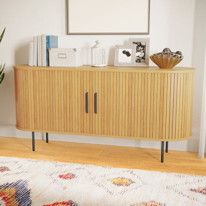 The Aaron 140cm Curved Sideboard Buffet - Natural features a mid-century design with rounded front, fluted wooden doors, slim black metal legs, and is topped with books, decor, and framed photos.