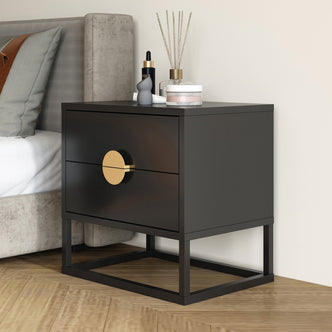Abigail 55cm 2 Drawer Bedside Table - Black/Gold, featuring a matte black finish with gold round handles, two drawers, and an open metal base, complemented by decorative items on top.