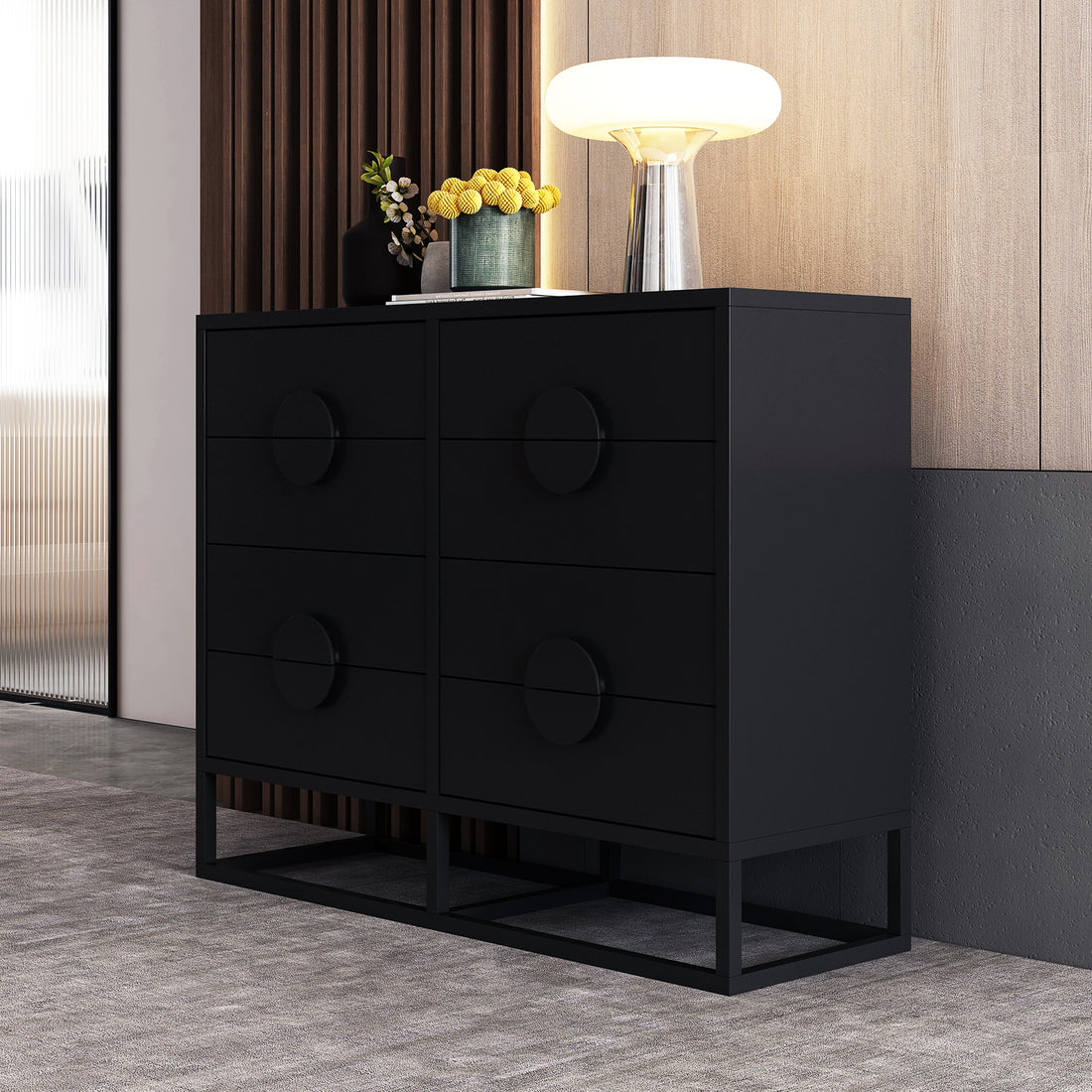 Abigail 120cm Lowboy Dresser with Drawers - Black shown with six drawers, a matte-black finish, and set on an open metal base. Topped with vases and a lamp.