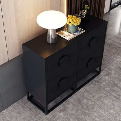 Abigail 120cm Lowboy Dresser with Drawers - Black, featuring six drawers with circular pulls, topped with a glowing mushroom lamp, books, and vases, set on a light gray carpet.