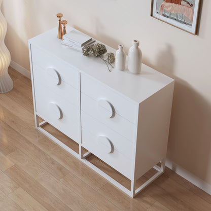 Abigail 120cm Lowboy Dresser with Drawers - White, featuring a minimalist design with graphic round pulls, topped with rose-gold candle holders, white books, vases, and dried hydrangea on a wooden floor.