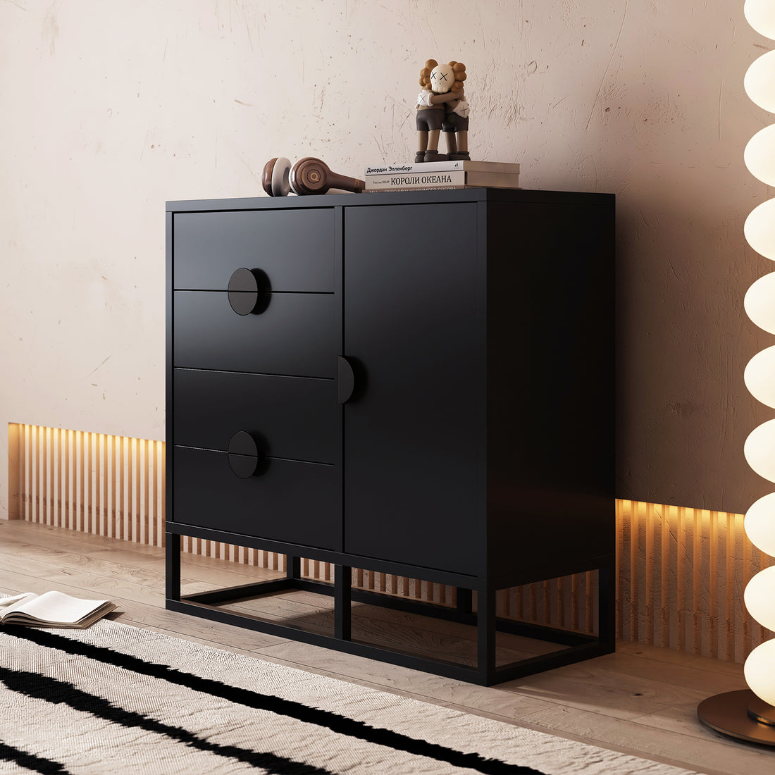 Abigail 100cm Sideboard Buffet Table - Black; features three drawers with circular pulls and a cabinet door. A sculptural lamp and art-toy figurine complement the contemporary setting.