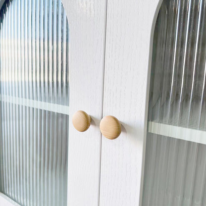 Afra 80cm Buffet Cabinet with Glass Doors in White & Natural, showcasing vertically fluted glass panels, round wooden knobs, and a glimpse of the interior shelf through the elegant cabinet doors.