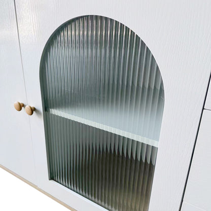Afra 80cm Buffet Cabinet with Glass Doors features a close-up of its white wooden frame, showcasing an arched, vertically fluted glass panel door and two round wooden knobs on an adjoining solid door.