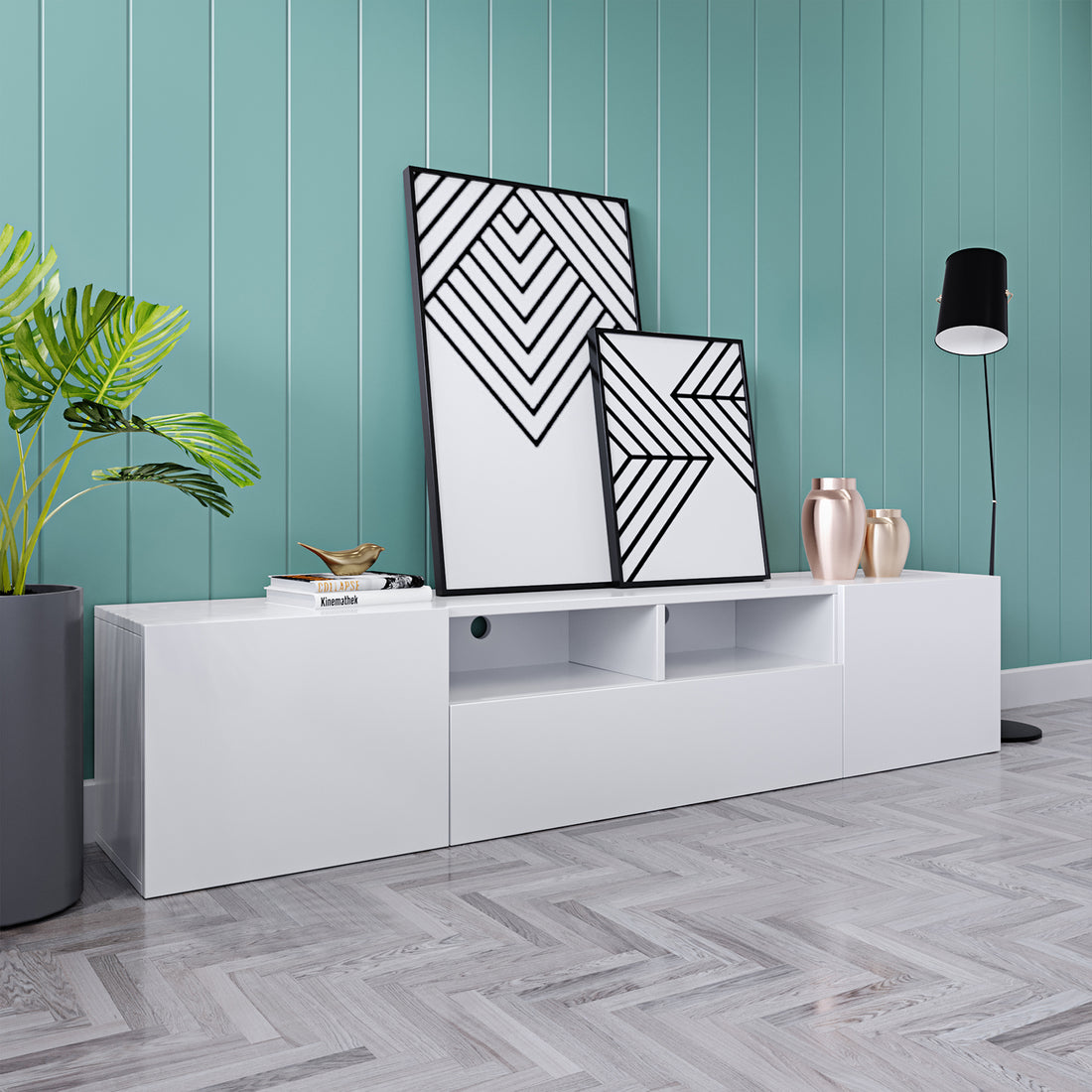 Anton 200cm Entertainment TV Unit in White, featuring a glossy finish on a herringbone-patterned floor, topped with books and decor, flanked by abstract art and a potted plant.