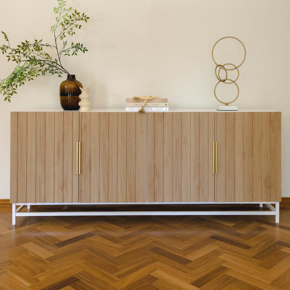 Argus 180cm Sideboard Buffet Table with Steel Legs - Natural, featuring a sleek fluted door design and sturdy steel legs, set in an indoor space with a decorative vase on top.