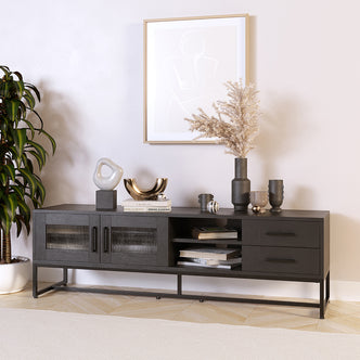 Ashley 160cm TV Unit with Fluted Glass Door Black features glass-paneled doors, open cubbies, and drawers. Styled with decorative items, it showcases sleek design elements and functional storage options.