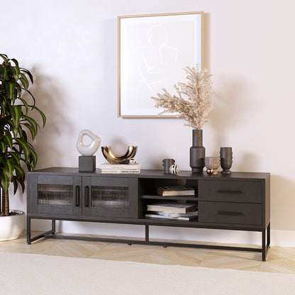 Ashley 160cm TV Unit with Fluted Glass Door Black features glass-paneled doors, open cubbies, and drawers. Styled with decorative items, it showcases sleek design elements and functional storage options.