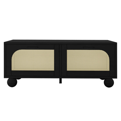 Carlo 110cm Rattan Coffee Table with Storage in Black features two front doors with woven cane panels and sits on spherical feet, blending modern design with functional storage.