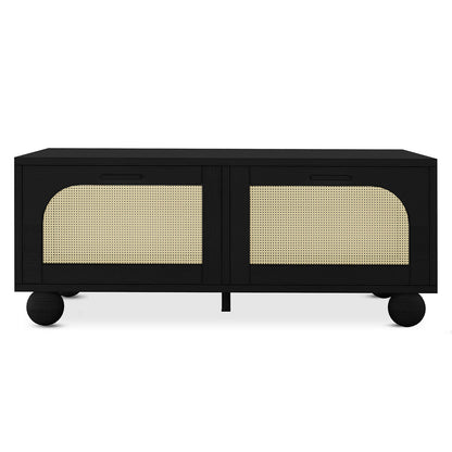 Carlo 110cm Rattan Coffee Table with Storage in Black features a matte black finish, sliding doors with semi-circular natural cane panels, and round feet. Ideal for storing essentials stylishly.