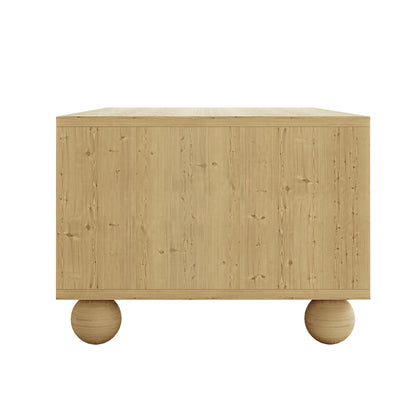 Carlo 110cm Rattan Coffee Table with Storage in Natural, featuring a minimalist, box-shaped design with light-toned wood and two oversized wooden sphere legs, offering a sleek, handleless front.