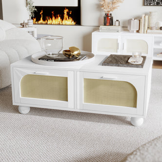 Carlo 110cm Rattan Coffee Table with Storage in White features two cane-front drawers, round ball feet, and a sleek, modern design, complemented by decorative items on top, set in a stylish living room.