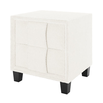 Crossandra Boucle Bedside Table in Cream White, featuring off-white boucle upholstery, four-panel tufted design, and short tapered black wooden legs, offering a chic and functional addition to bedroom decor.