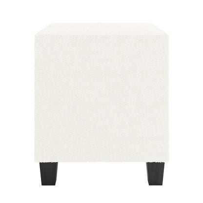 Crossandra 2 Drawer Fabric Bedside Table in Cream White, cube-shaped, upholstered in soft bouclé fabric, with four short, dark tapered legs, offering a chic and practical addition to any bedroom.