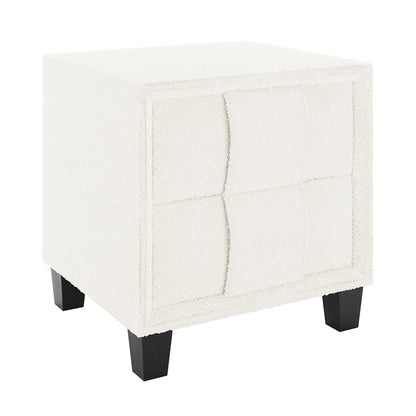 Crossandra 2 Drawer Fabric Bedside Table in Cream White features a textured bouclé upholstery, subtly curved drawer fronts, and dark-stained wooden legs, offering a chic and functional addition to your bedroom.