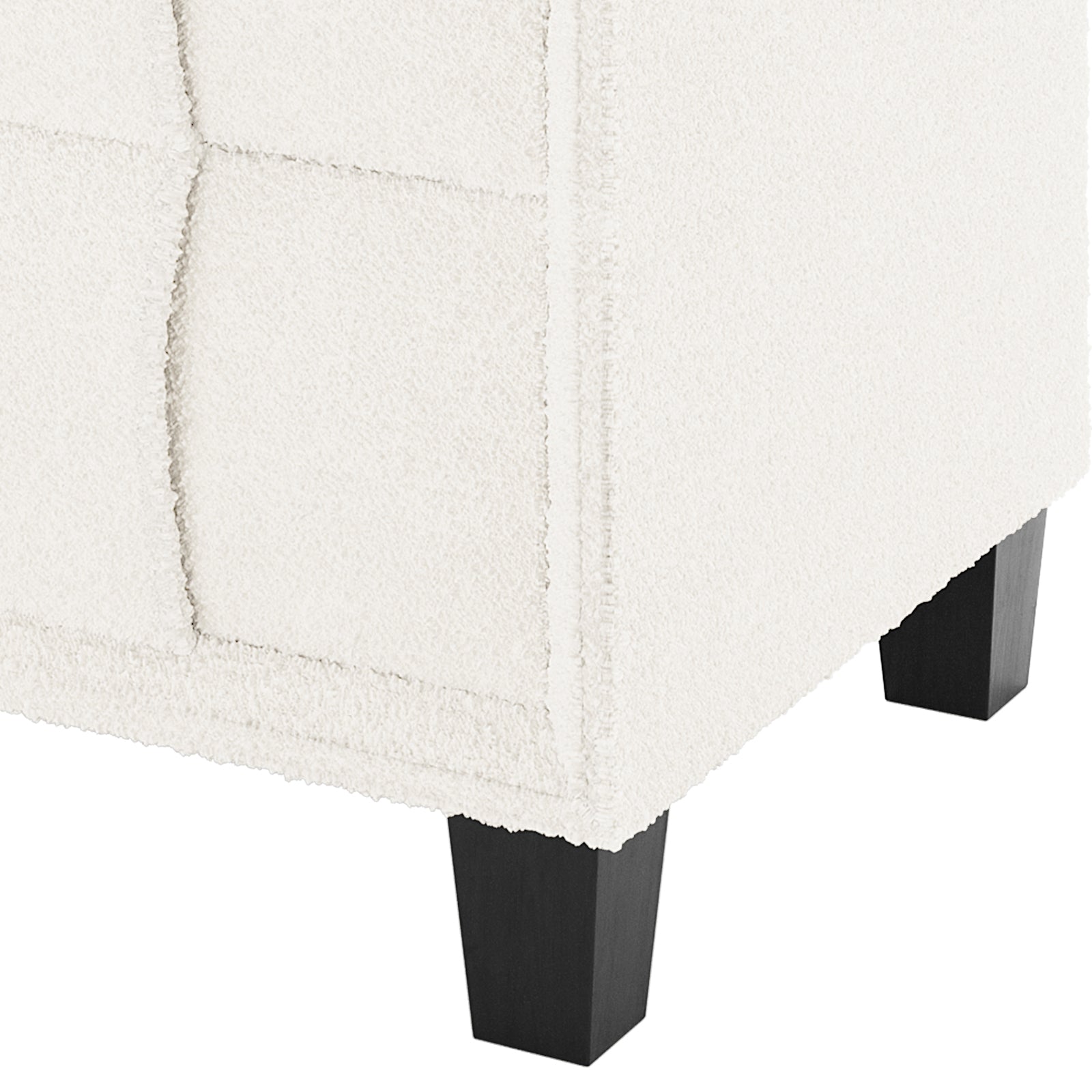 Close-up of the Crossandra Boucle Bedside Table in Cream White, showcasing textured boucle fabric and dark wooden legs, highlighting its elegant and modern design.