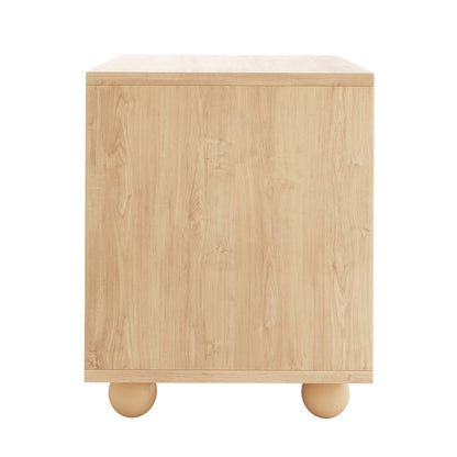 Dialga 45cm Rattan Bedside Table with Storage, featuring a cube shape with light oak finish, smooth front panel, and two round wooden feet.