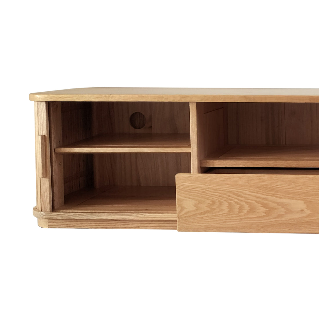 Close-up of Eddie 200cm Hardwood Oak TV Entertainment Unit in Natural, featuring a left open cubby with a shelf and cable hole, and a right partially open drawer front.